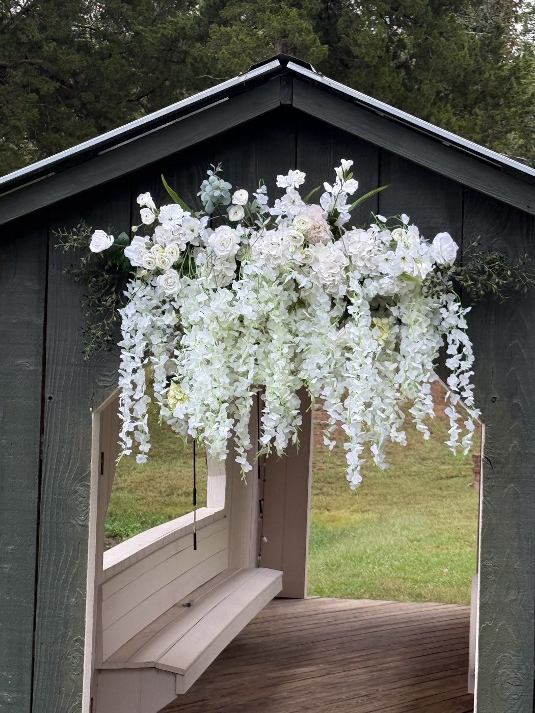 White flowers draped over an arbor