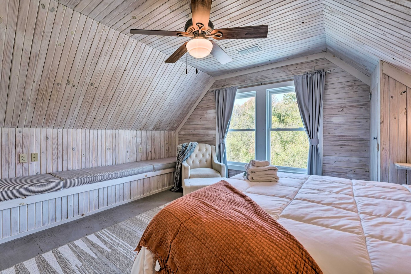 Loft bedroom with an armchair by the window