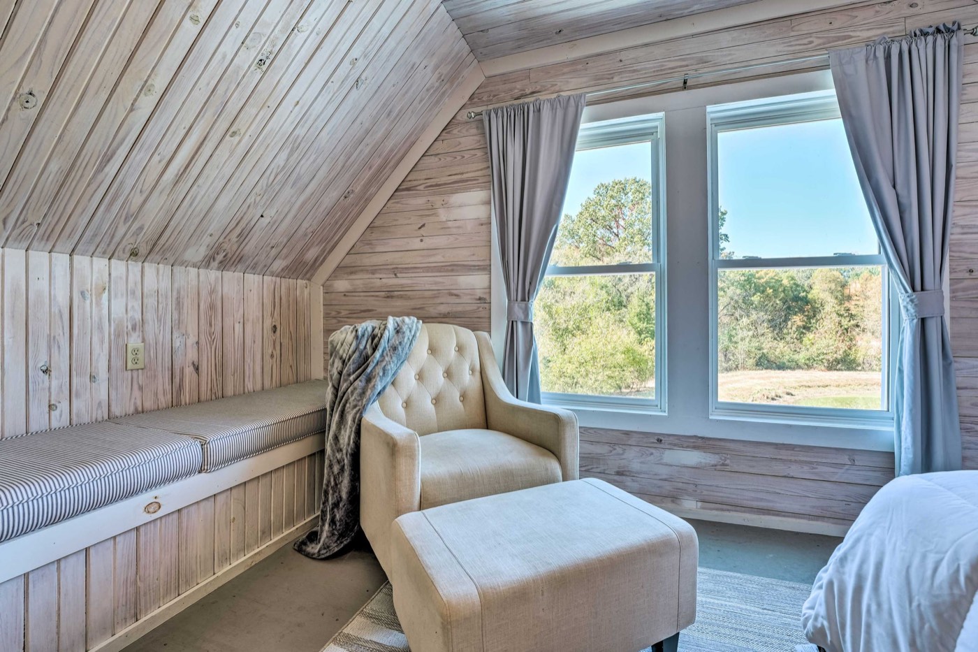 Armchair and footstool by a window in the Loft